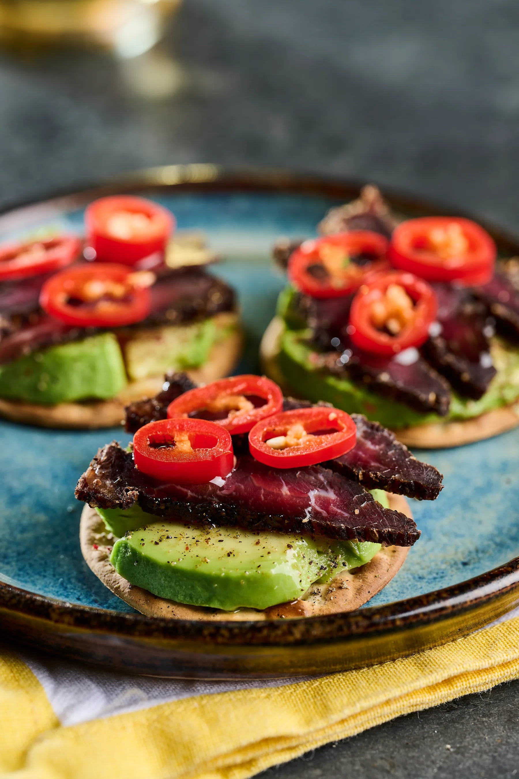 Joburg Steak Slices served over avocado with fresh red pepper